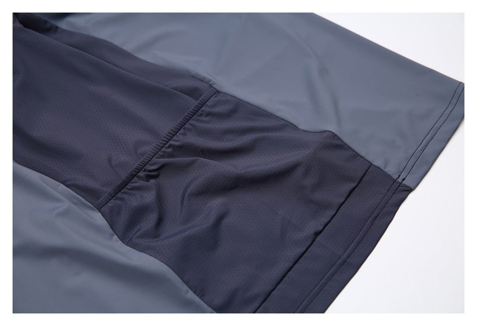 Close-up of slate-gray and dark perforated panels with a stitched hem.