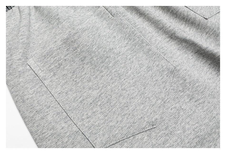Close-up of heather-gray pants fabric and stitching around a large patch pocket.
