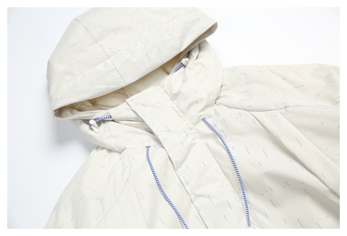 Angled close view of the jacket hood, front placket, and blue-and-white drawcords.