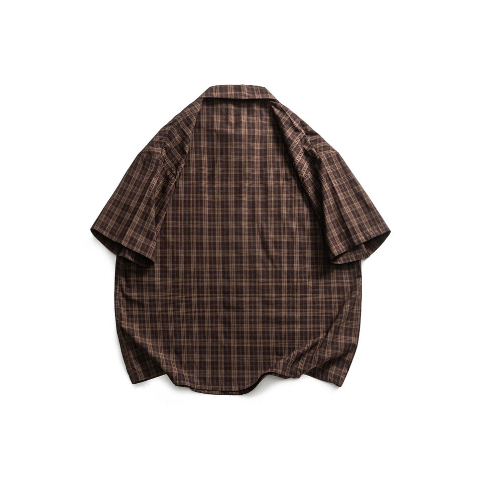 Back view of a dark brown short-sleeve button-up shirt with a fine plaid pattern, laid flat on white.