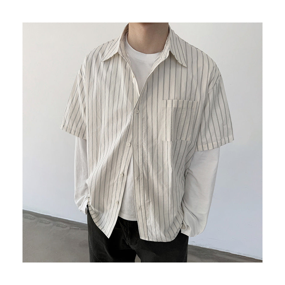 Close view of a model wearing the striped short-sleeve shirt open over a white tee, showing collar and chest pocket
