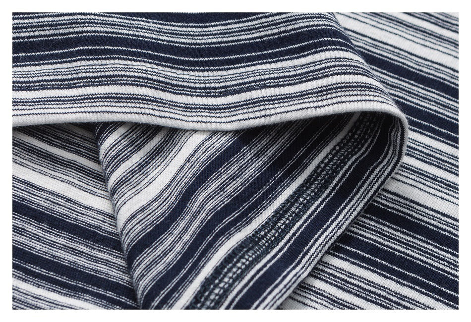 Close-up of folded navy and white fabric with fine horizontal stripes and varied knit textures.