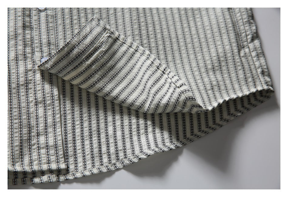 Close-up of the striped shirt's layered fabric and finished edge.