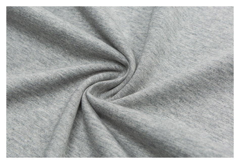 Close-up of gray heather fabric gathered into soft folds, showing its fine knit texture.