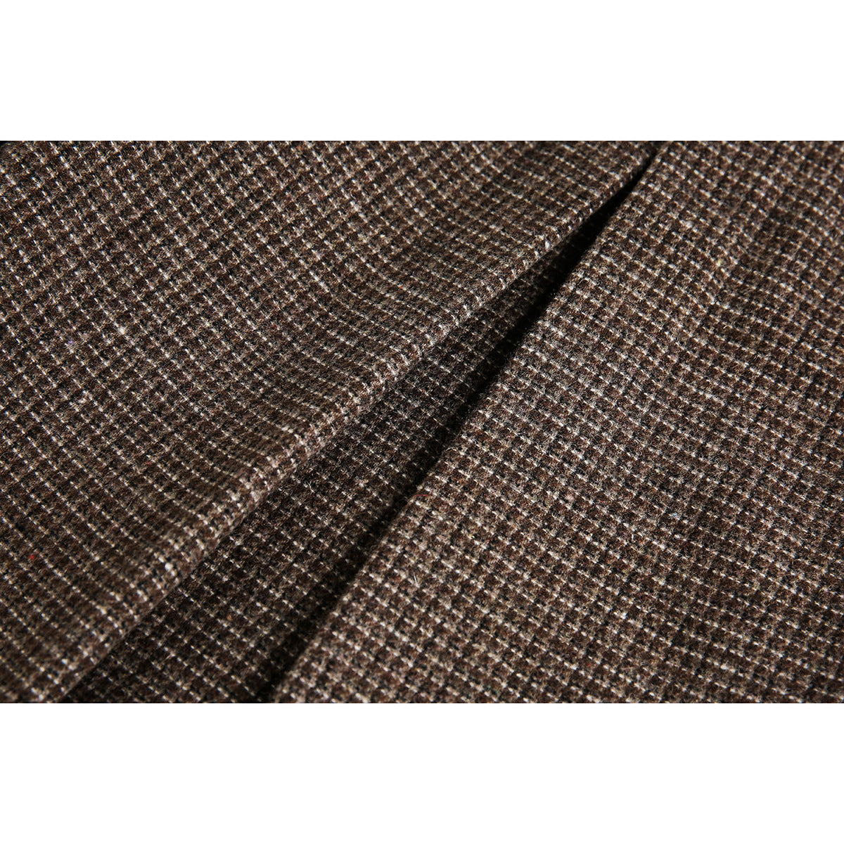 Close-up of brown small-check fabric and a stitched seam.