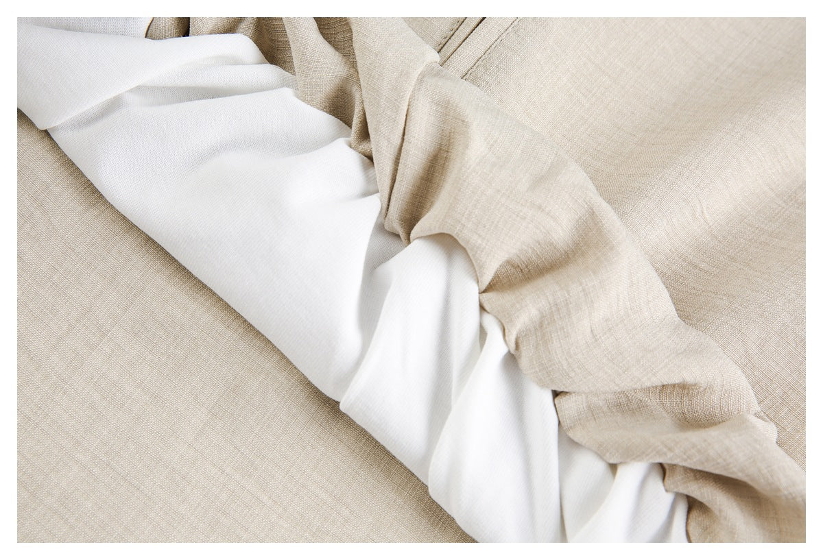 Close-up of beige garment fabric folded around a white lining.
