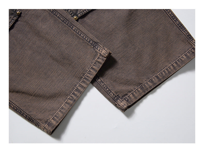 Close-up of the stitched hems and overlapping edges of brown garment panels laid flat.
