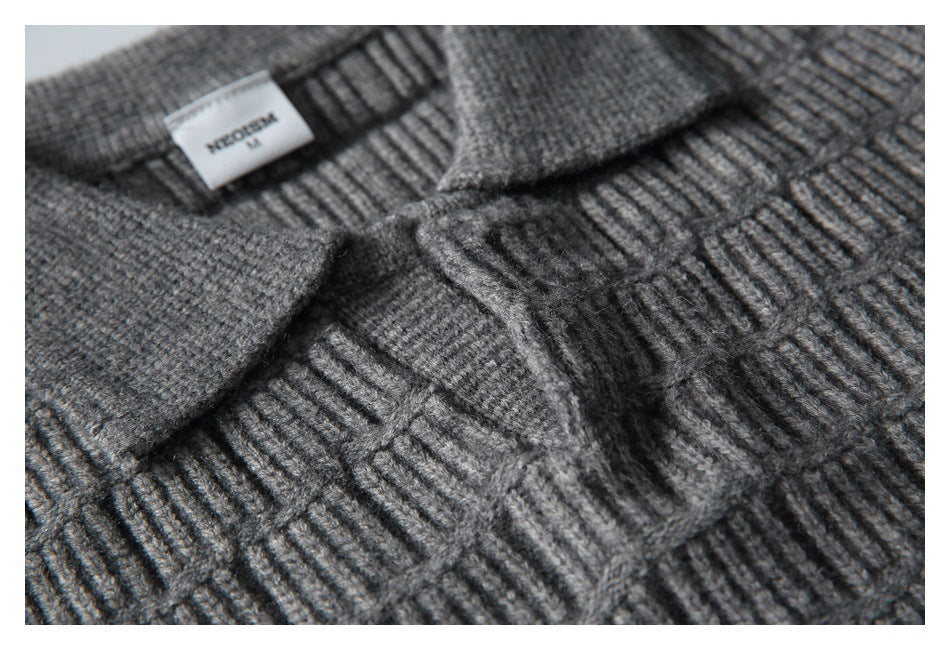 Angled close-up of the sweater’s collar and raised geometric knit pattern.