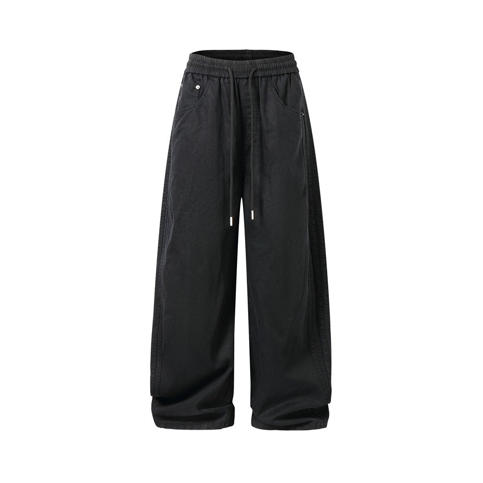 Full front view of wide-leg black pants with an elastic drawstring waist, front pockets, and long legs.