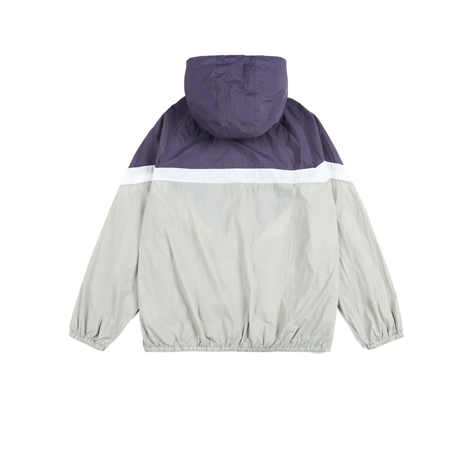 Back view of a hooded color-block windbreaker with a dark purple upper section and pale gray body and sleeves.