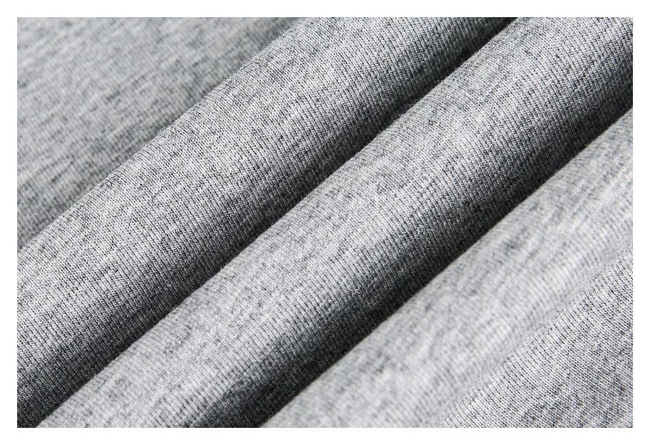 Close-up of heather gray knit fabric folded into soft diagonal ridges.