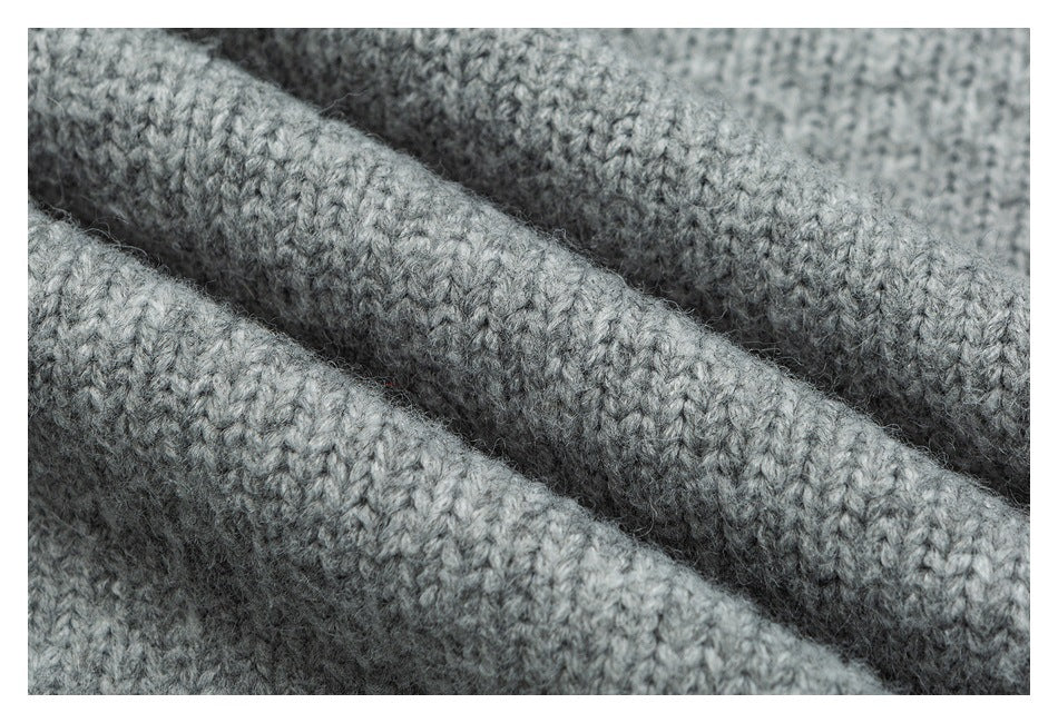 Macro view of the soft-looking gray knit texture, showing raised stitches and folds.