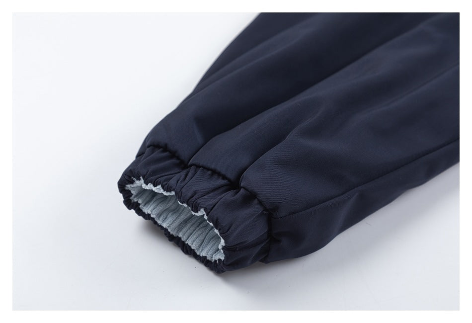 Close-up of an elasticated dark navy cuff with pale blue ribbed lining.