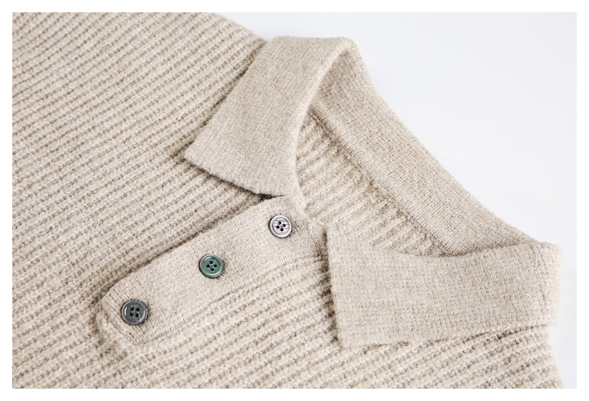Close-up of a beige knit top's wide collar, textured knit, and three-button placket.