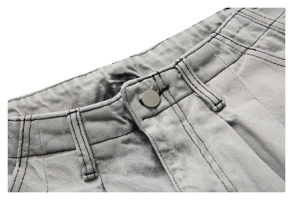 Detail of the gray washed denim shorts' waistband, metal button, belt loop and fly stitching.