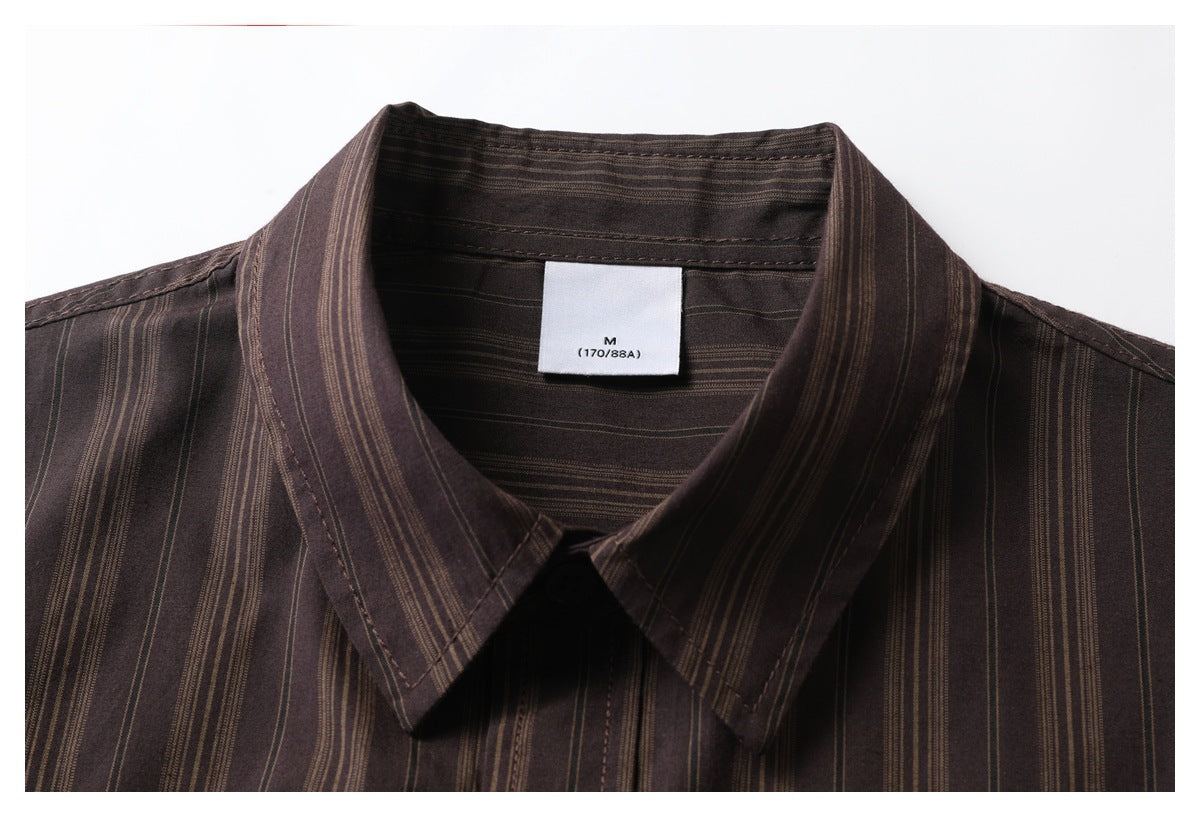 Close-up of a dark brown shirt collar with narrow tan vertical stripes and a visible M size label.