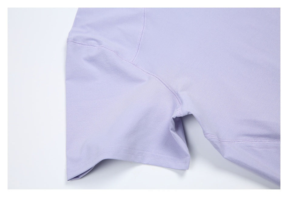 Close-up of the lavender shirt’s side and underarm seams with a short sleeve hem.