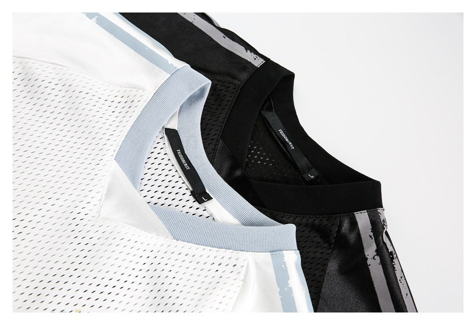 Close-up of white and black mesh jerseys with pale blue-gray trim and striped shoulder panels.