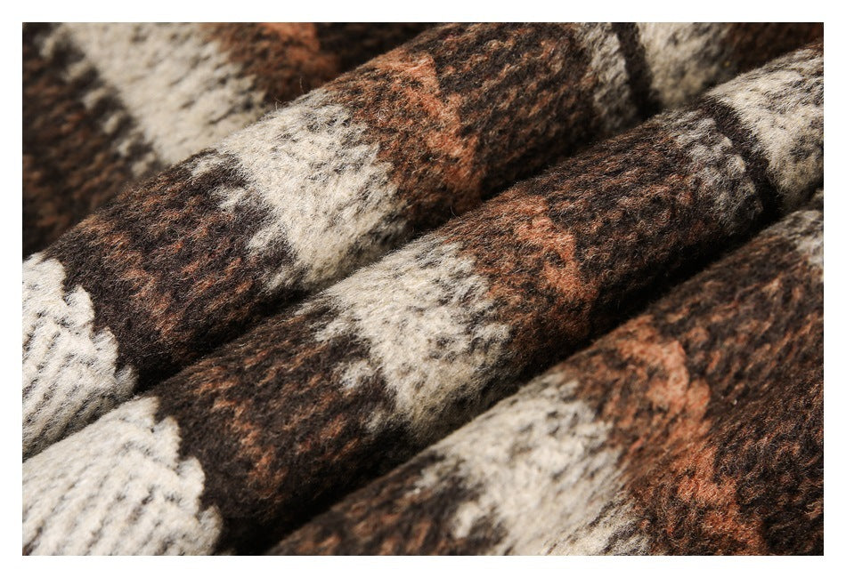 Close-up of brown, rust, cream, and dark patterned fabric with a fuzzy surface.
