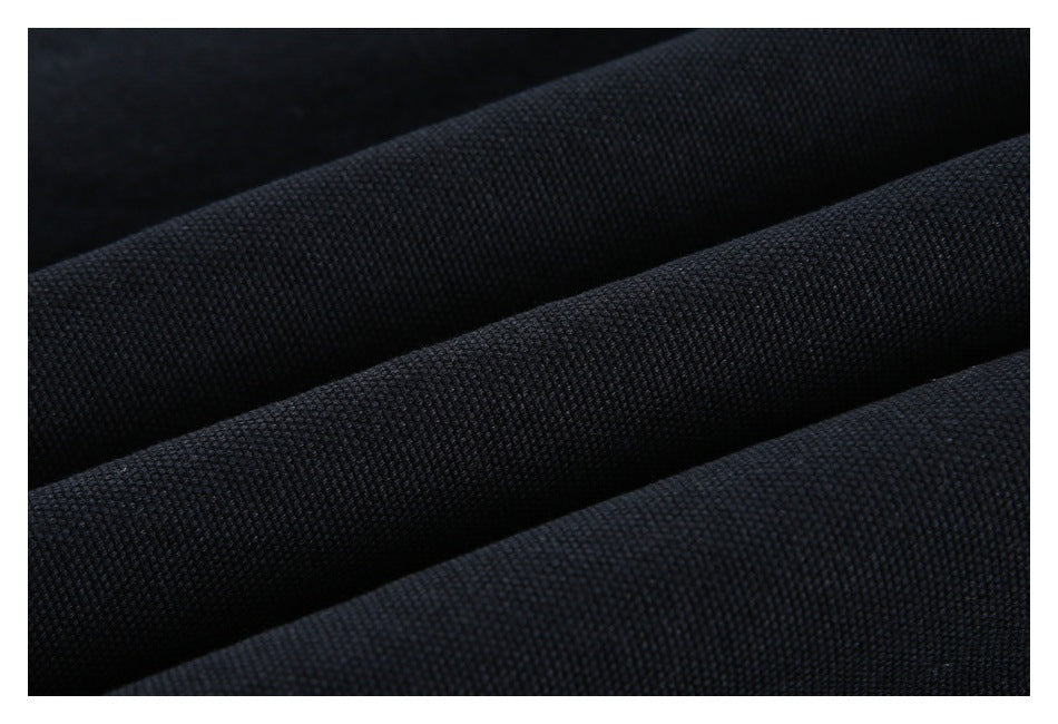 Close-up of dark navy-black textured fabric arranged in soft folds.