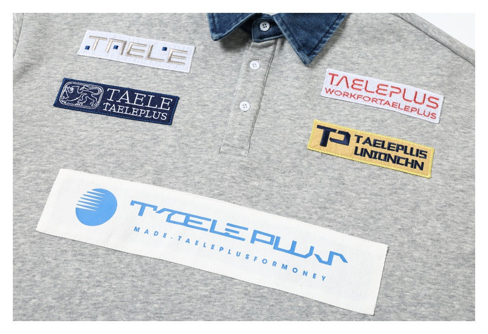 Close-up of a gray polo shirt front with several colorful embroidered brand patches and a button placket.