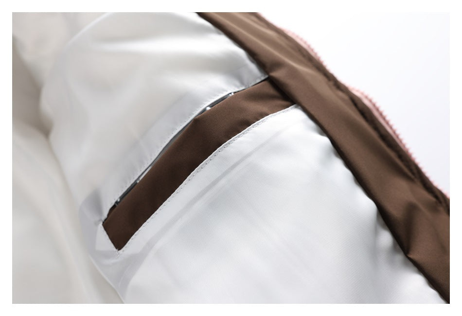 Close-up of the jacket's light-colored inner lining with a brown strip and narrow dark trim.