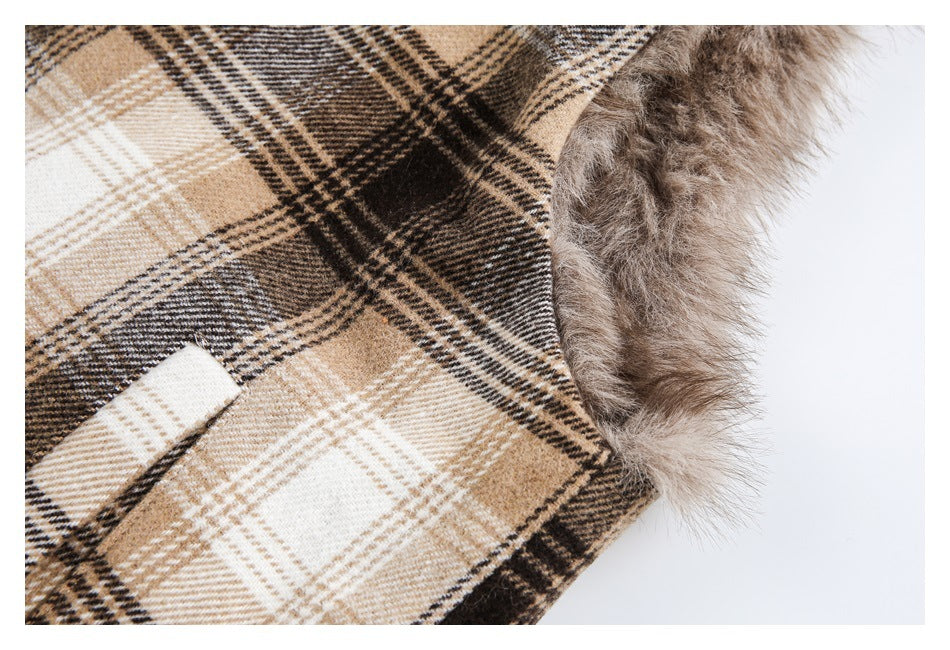 Close-up of the plaid coat's faux-fur-trimmed edge and a narrow fabric detail.