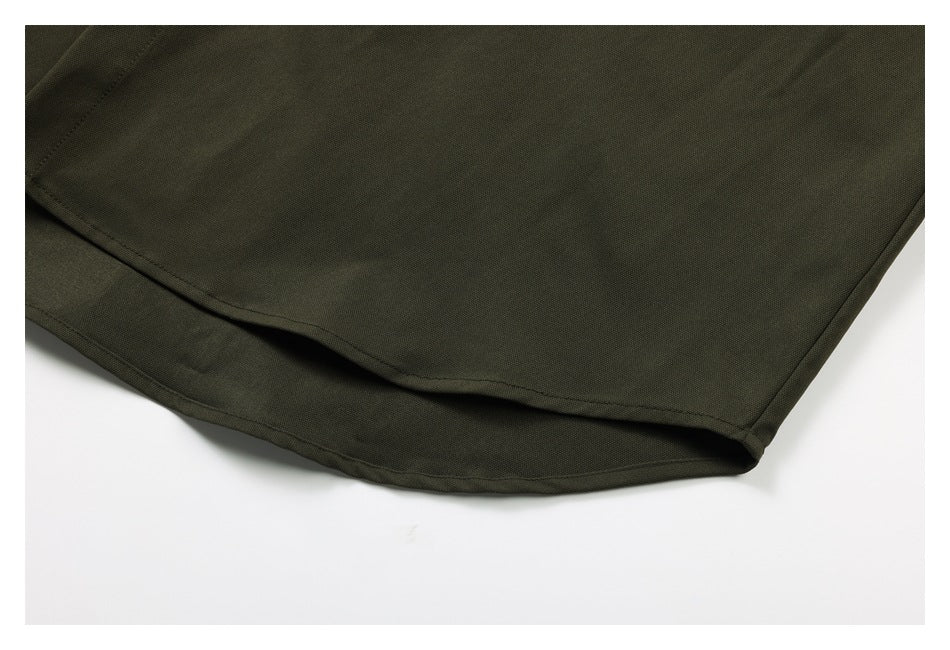 Close-up of the olive-green shirt's curved lower hem and stitched edge.