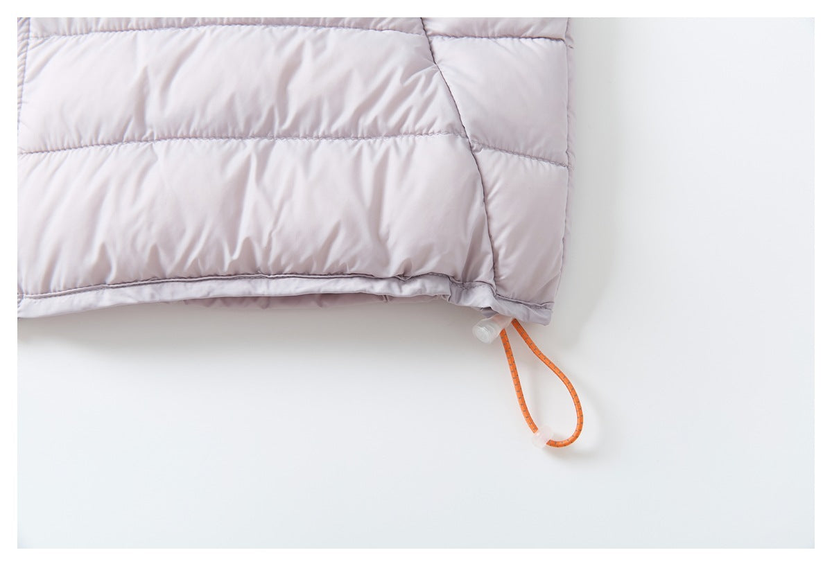 Close-up of a pale lavender quilted jacket hem with an orange elastic drawcord and clear toggle.