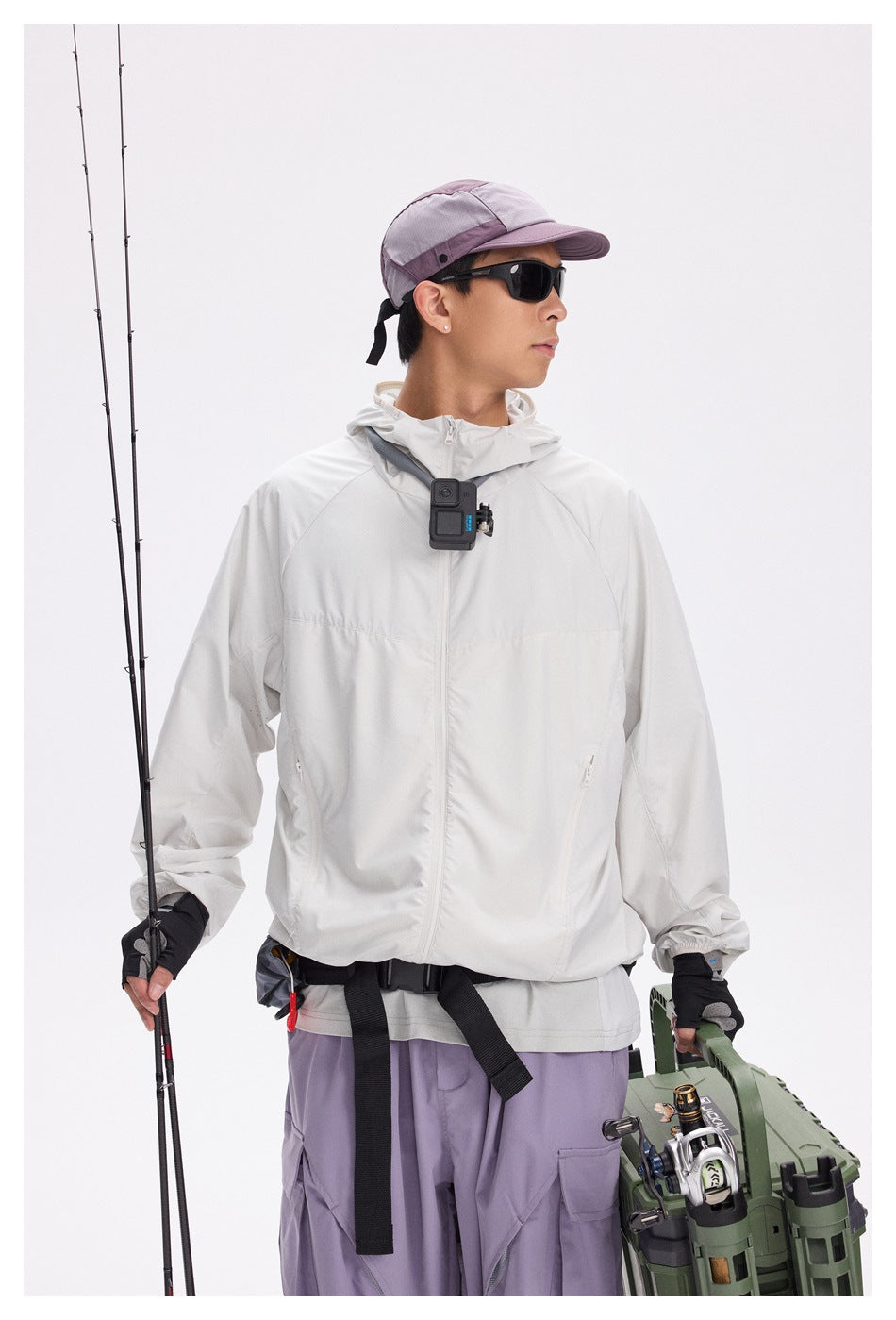Model in a white hooded zip jacket and lavender cargo pants, shown from the front at mid-length with fishing gear.