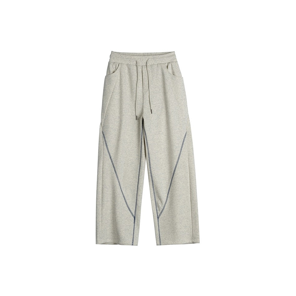 Heathered light beige-gray drawstring sweatpants with diagonal blue-gray contrast stitching, front flat view
