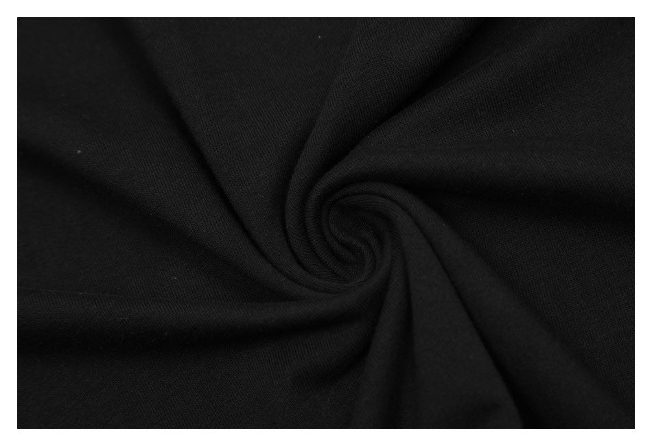 Close-up of black fabric gathered into a spiral, showing its surface and folds.