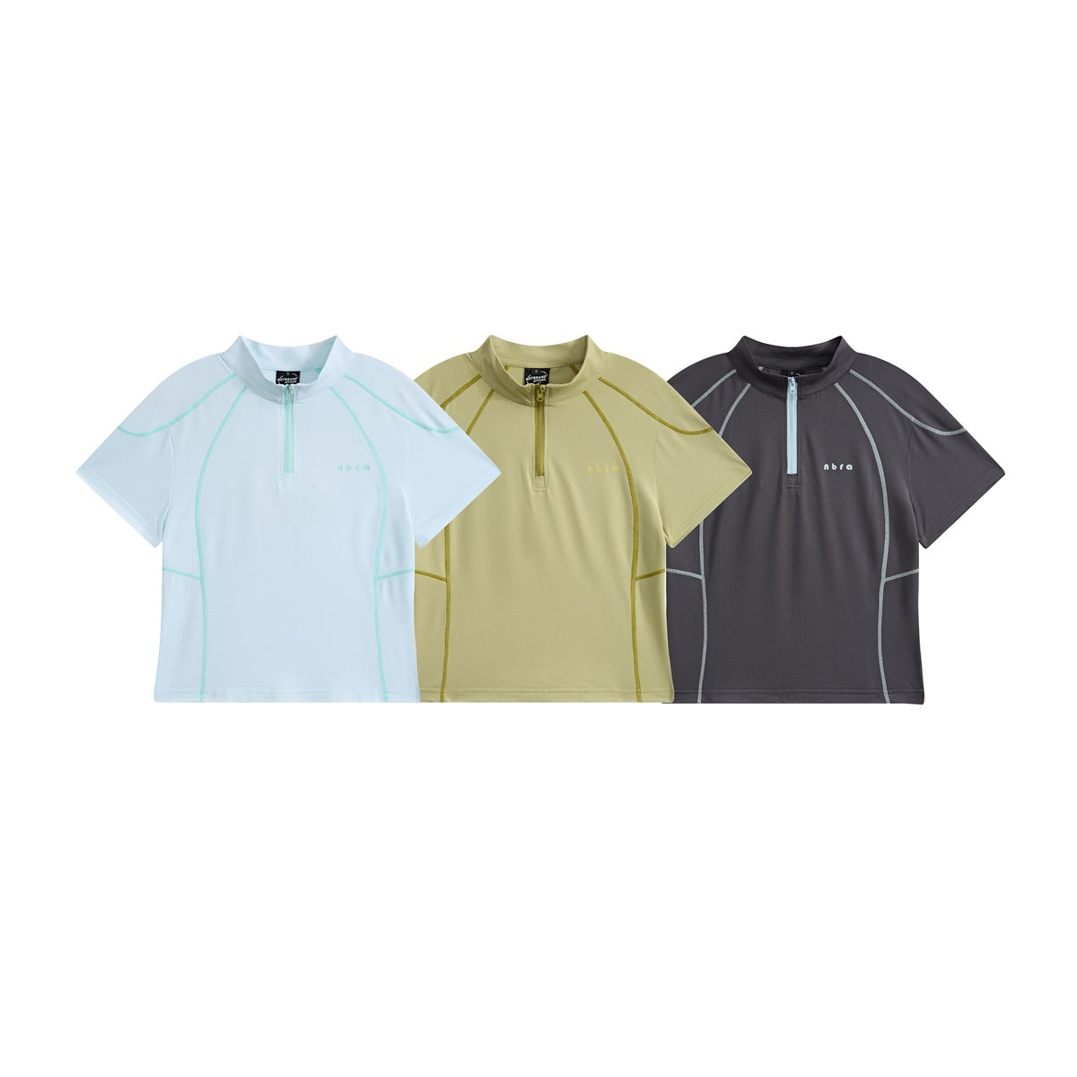 Three short-sleeve quarter-zip tops shown from the front in pale blue, light olive and charcoal with contrast seams.