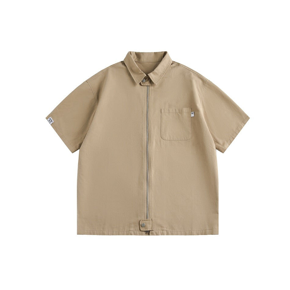 Khaki short-sleeve zip-front shirt with collar, chest pocket and hem snap tab, flat lay on white