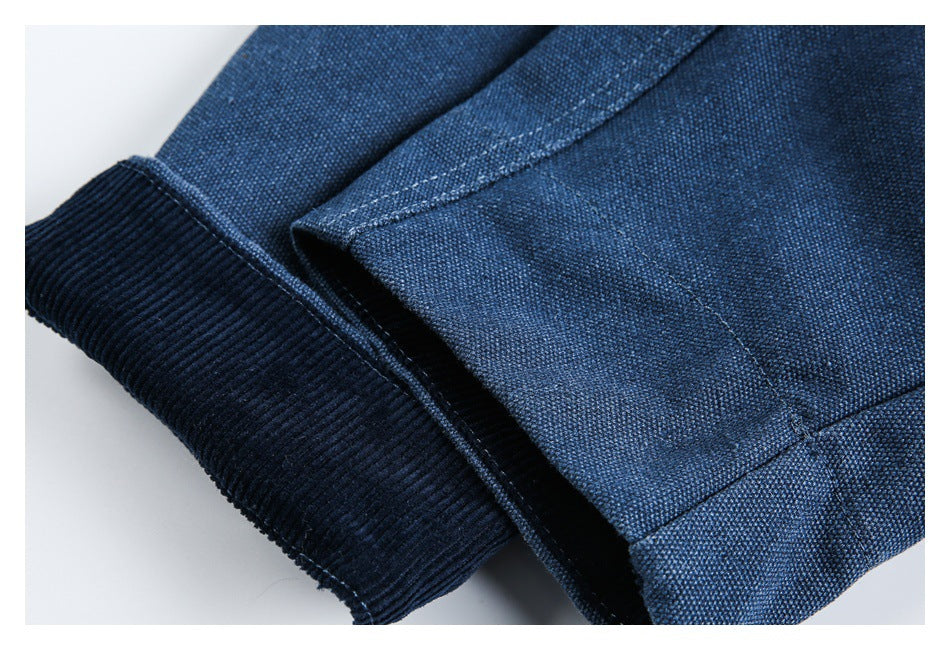 Close-up of a dark blue garment's ribbed cuff and stitched seam.