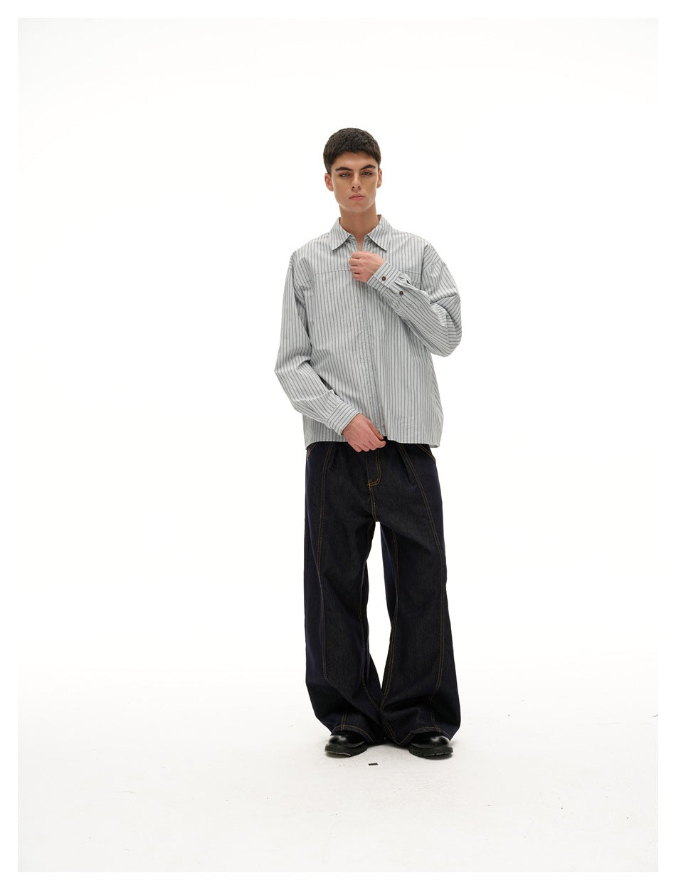 Front view of a model in a gray vertical-striped collared shirt with a chest pocket and pale blue zipper.