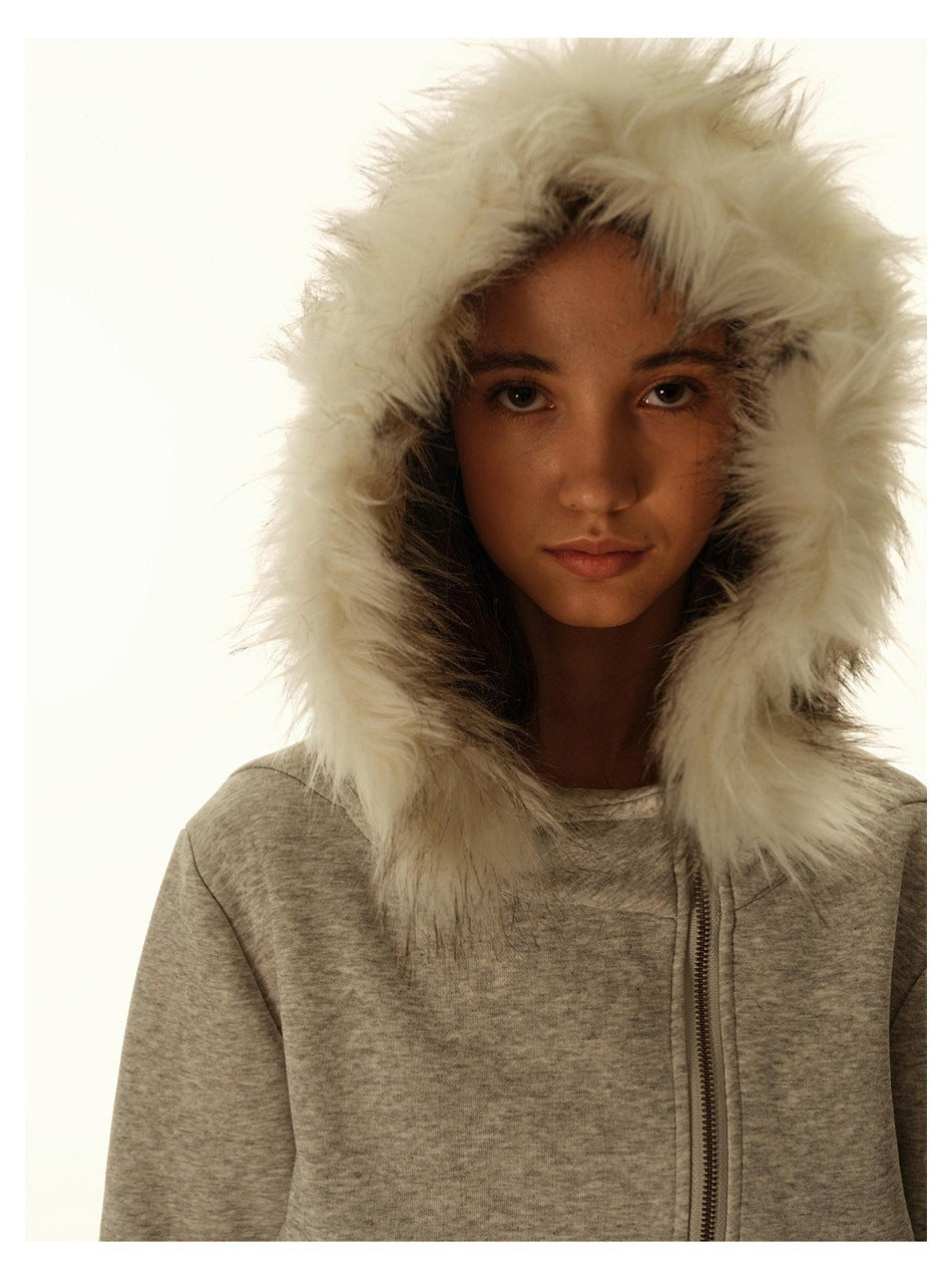Close-up of a model wearing the gray hoodie, showing its white faux-fur-trimmed hood and offset front zipper.