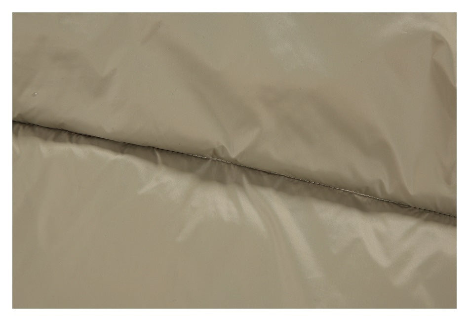 Close-up of a stitched seam across the smooth taupe outer fabric of the jacket.