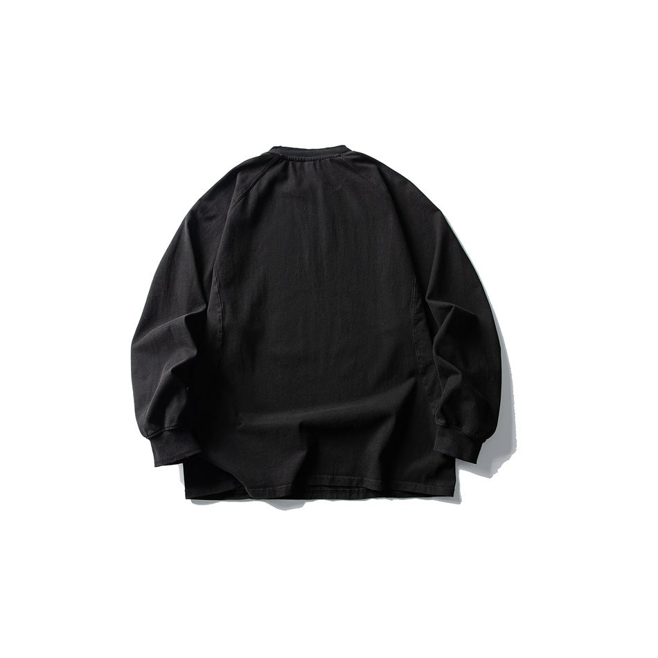Back view of a black long-sleeve crewneck shirt with raglan sleeves and ribbed cuffs.