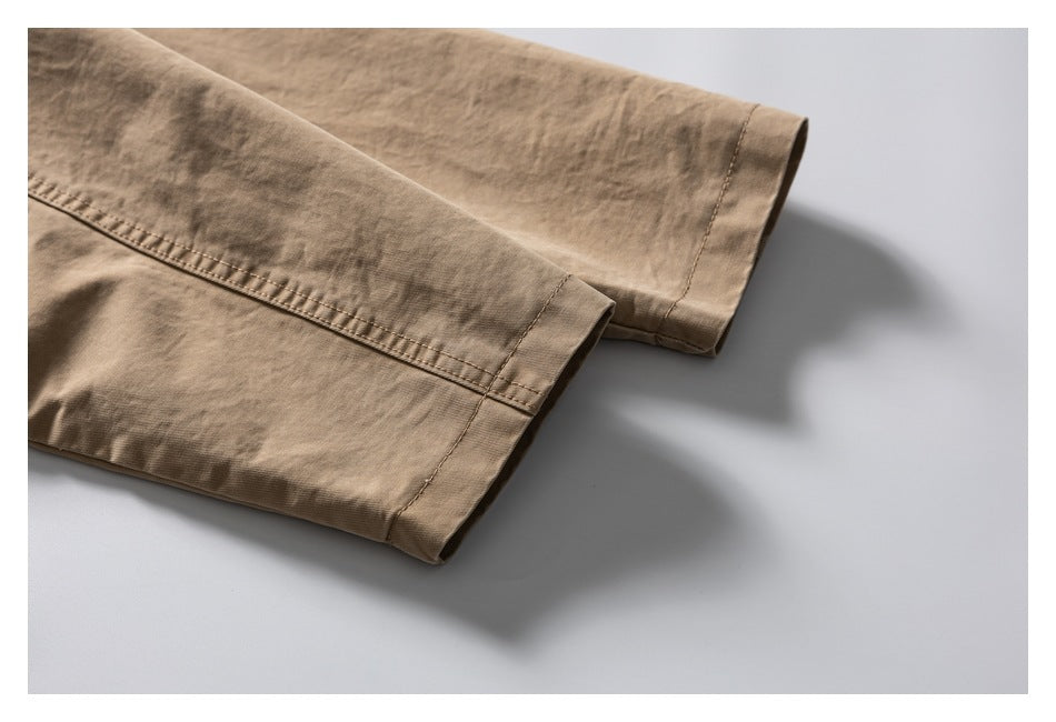 Close-up of the tan jacket's long sleeves and stitched cuffs.