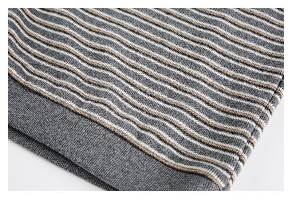 Close-up of the gray striped knit hem and solid ribbed waistband.
