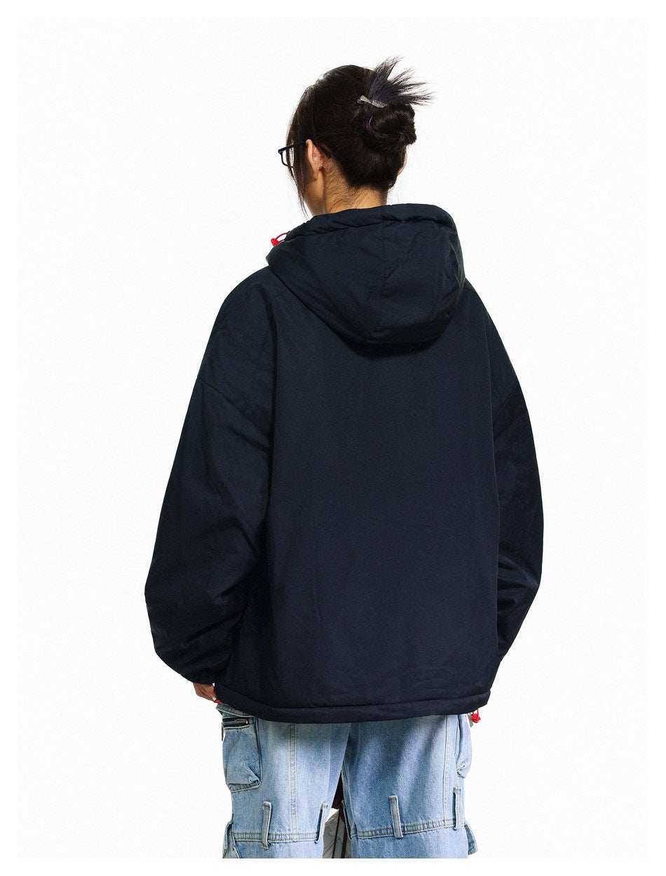 Back view of a model wearing an oversized black hooded jacket with a plain back.