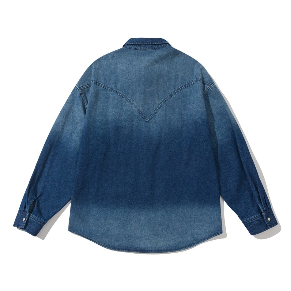 Back view of blue faded-wash denim shirt showing pointed western yoke and snap cuffs