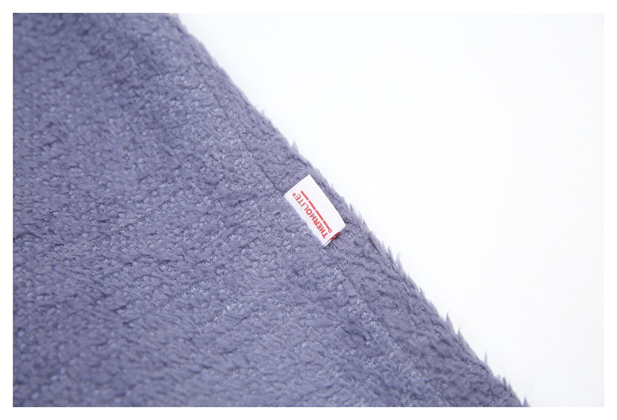 Close-up of fuzzy blue-gray fabric with a small white Thermolite label.