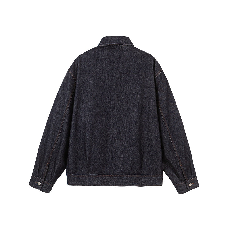 Back view of a dark indigo denim jacket with a pointed collar, long sleeves, button cuffs, and straight hem.