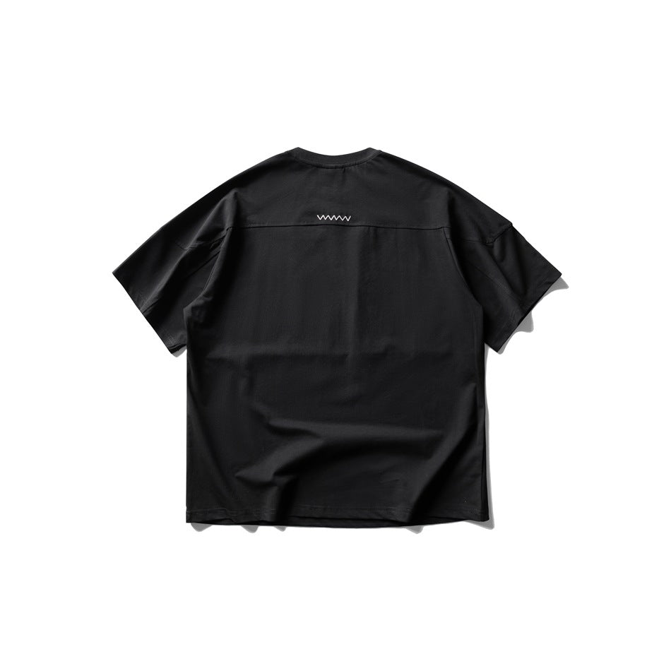 Back view of a black short-sleeve crew-neck T-shirt with a small white zigzag detail across the upper back.