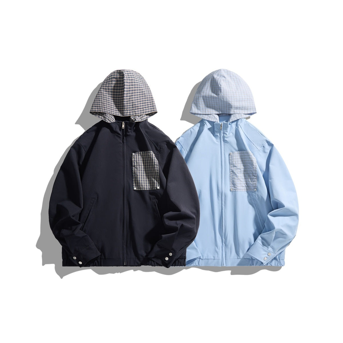 Two hooded zip jackets shown from the front: one navy and one light blue, both with plaid hoods and chest pockets.