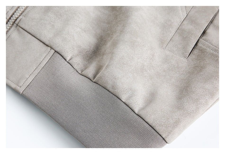 Close-up of the light gray jacket's lower panel, seam, and wide ribbed hem.