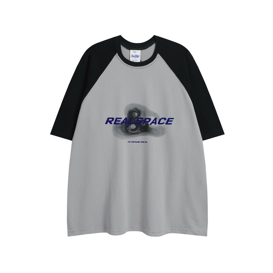 Gray and black raglan short-sleeve T-shirt with blue lettering and graphic on chest, flat lay