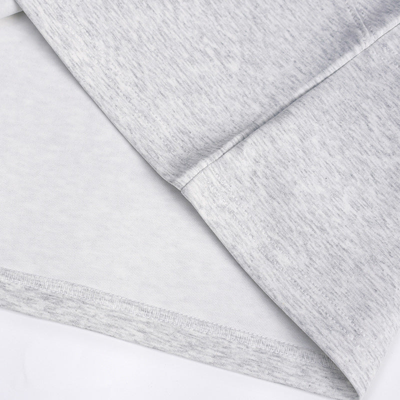 Close-up of the heather gray T-shirt sleeve and stitched hem.